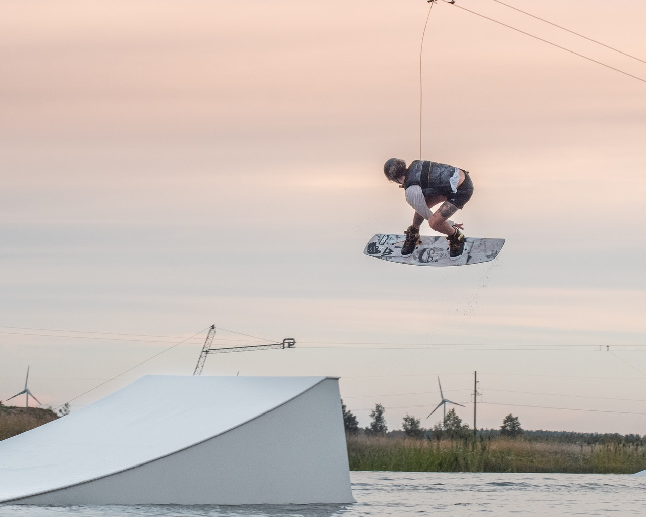 Wakeboarder grabbing the board in mid-air